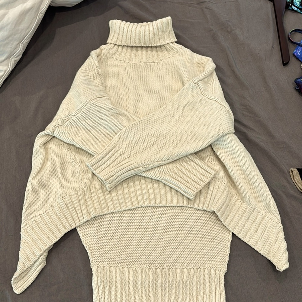 Cream turtle neck sweater.